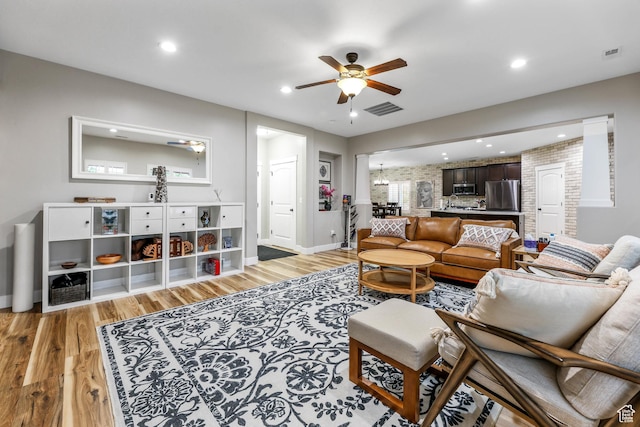 5764 Greenwich Cir, Stansbury Park, UT 84074 - living room with light wood-style floors, ceiling fan, recessed lighting, and visible vents