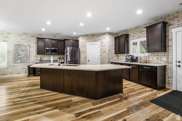 5764 Greenwich Cir, Stansbury Park, UT 84074 - kitchen with light countertops, dark brown cabinetry, stainless steel appliances, and a sink