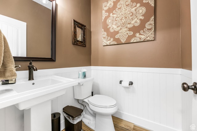 5764 Greenwich Cir, Stansbury Park, UT 84074 - bathroom with toilet, wainscoting, and wood finished floors