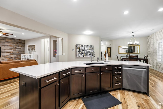 5764 Greenwich Cir, Stansbury Park, UT 84074 - kitchen with open floor plan, light countertops, a sink, light wood-style flooring, and dishwasher