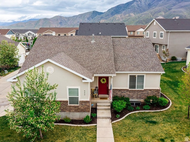 940 N 90 W, Santaquin, UT 84655 - view of front of house with brick siding, roof with shingles, stucco siding, and a mountain view