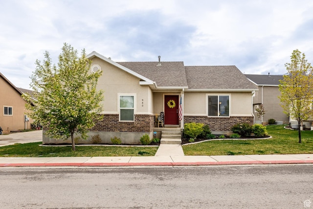940 N 90 W, Santaquin, UT 84655 - view of front of house with brick siding, a front yard, stucco siding, and roof with shingles