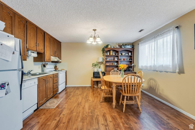 161 E 700 N Unit 10, Provo, UT 84606 - dining room with a textured ceiling, an inviting chandelier, baseboards, and light wood finished floors