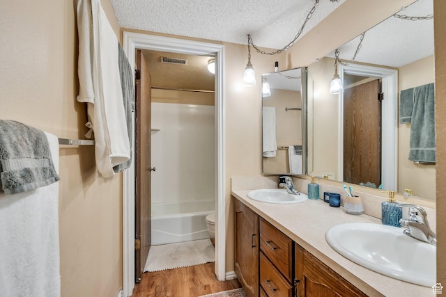 161 E 700 N Unit 10, Provo, UT 84606 - full bath featuring a textured ceiling, visible vents, a sink, and wood finished floors
