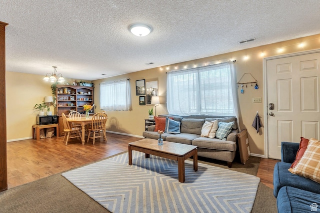 161 E 700 N Unit 10, Provo, UT 84606 - living room with visible vents, plenty of natural light, wood finished floors, and a chandelier