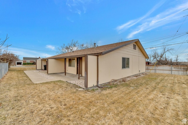 back of property featuring a patio, a lawn, fence, and roof with shingles