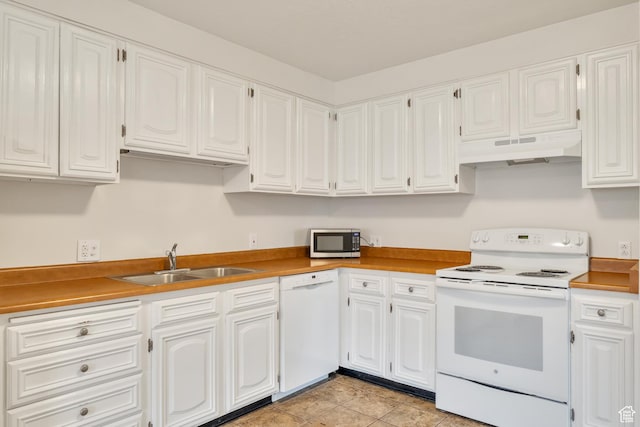 kitchen featuring a sink, under cabinet range hood, white cabinets, and white appliances