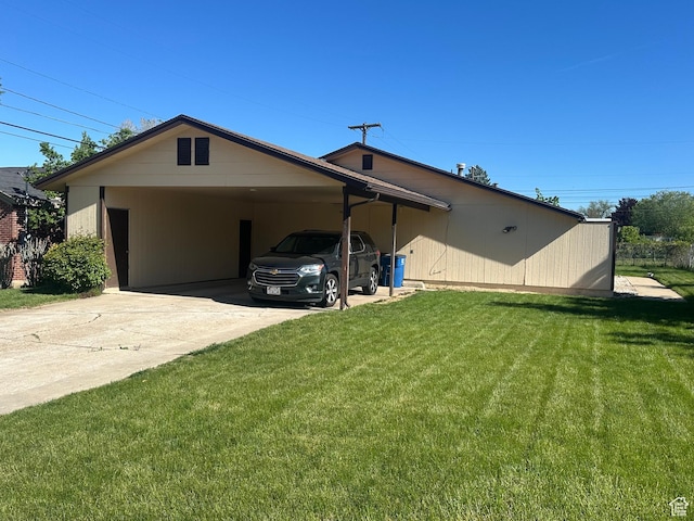 view of front facade with driveway, a front yard, and a carport
