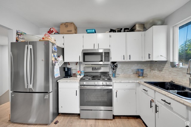7979 W 3320 S, Magna, UT 84044 - kitchen featuring light countertops, a sink, backsplash, and stainless steel appliances