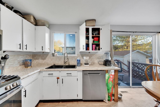 7979 W 3320 S, Magna, UT 84044 - kitchen with a sink, white cabinets, a wealth of natural light, and stainless steel appliances