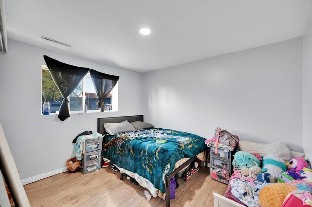 7979 W 3320 S, Magna, UT 84044 - bedroom featuring baseboards, recessed lighting, wood finished floors, and visible vents
