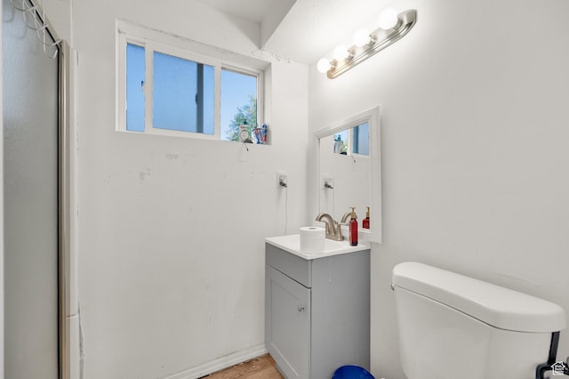 7979 W 3320 S, Magna, UT 84044 - bathroom featuring vanity, wood finished floors, and toilet