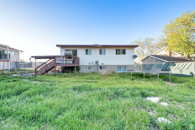 7979 W 3320 S, Magna, UT 84044 - rear view of house with a trampoline, fence, stairway, and a deck