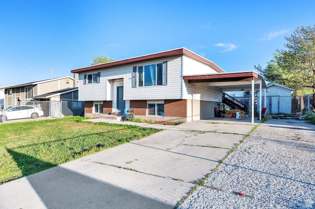 7979 W 3320 S, Magna, UT 84044 - split foyer home with fence, driveway, a front yard, and an attached carport