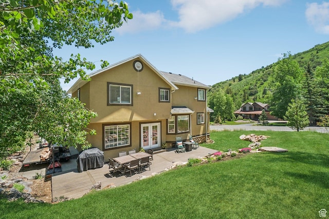 8030 N Springshire Dr, Park City, UT 84098 - back of house featuring stucco siding, french doors, a lawn, and a patio