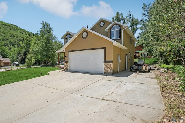 8030 N Springshire Dr, Park City, UT 84098 - traditional-style house featuring stone siding, stucco siding, concrete driveway, a garage, and a front lawn