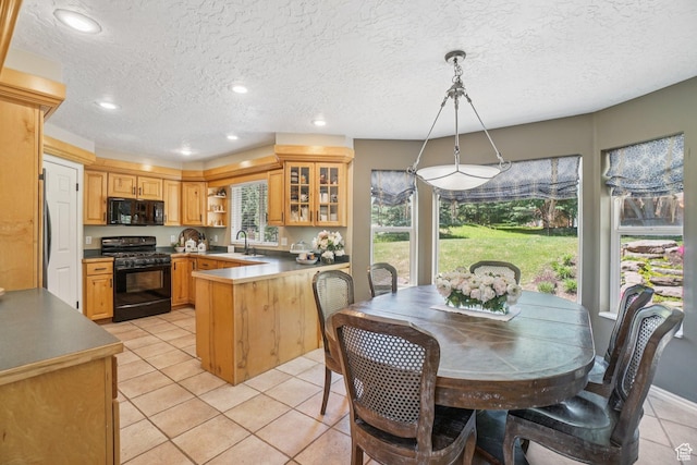 8030 N Springshire Dr, Park City, UT 84098 - kitchen with black appliances, a peninsula, light tile patterned floors, open shelves, and glass insert cabinets