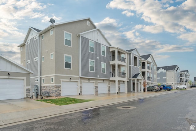 view of property with an attached garage and a residential view