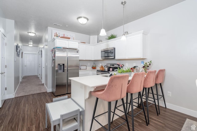 1809 W Terra Vista Ln Unit H101, Saratoga Springs, UT 84045 - kitchen with stainless steel appliances, a kitchen bar, dark wood-style floors, and a peninsula