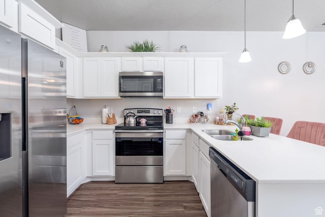 1809 W Terra Vista Ln Unit H101, Saratoga Springs, UT 84045 - kitchen featuring a peninsula, light countertops, white cabinets, a sink, and appliances with stainless steel finishes