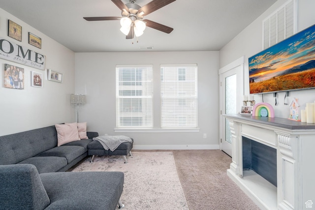 1809 W Terra Vista Ln Unit H101, Saratoga Springs, UT 84045 - carpeted living area featuring visible vents, a ceiling fan, baseboards, and a fireplace with raised hearth