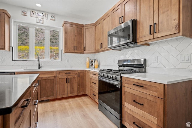 833 S 260 E, Willard, UT 84340 - kitchen featuring tasteful backsplash, a sink, light countertops, stainless steel appliances, and light wood-type flooring