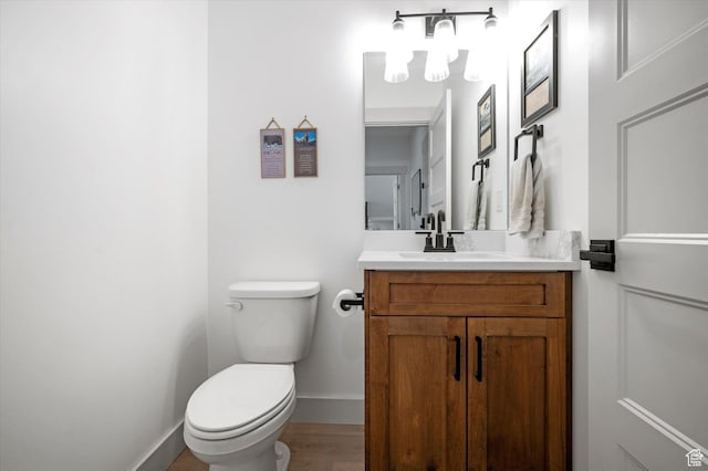 833 S 260 E, Willard, UT 84340 - half bathroom with vanity, toilet, a chandelier, baseboards, and wood finished floors