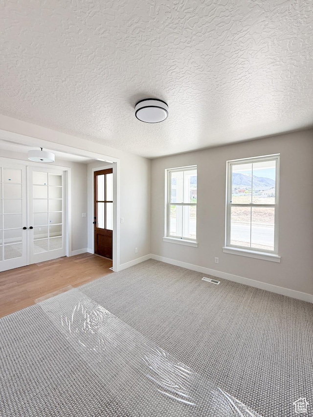 302 W Horizon View Loop Unit 35, Elk Ridge, UT 84651 - interior space featuring a textured ceiling, french doors, carpet, baseboards, and visible vents