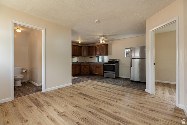 326 E 150 S, Kanab, UT 84741 - kitchen with ceiling fan, stainless steel appliances, a textured ceiling, and dark wood-type flooring
