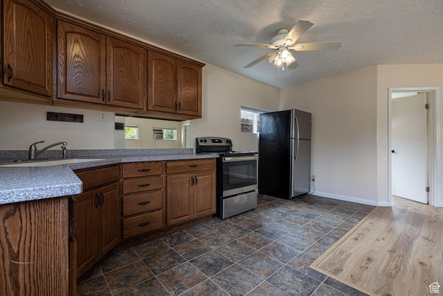 326 E 150 S, Kanab, UT 84741 - kitchen with baseboards, ceiling fan, brown cabinets, a sink, and appliances with stainless steel finishes