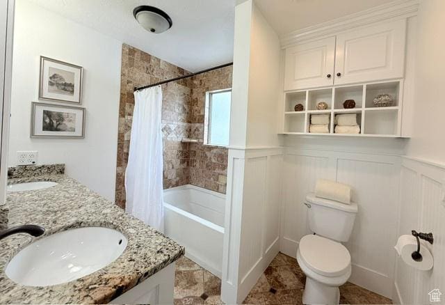 1170 N Main St, Orem, UT 84057 - bathroom featuring toilet, shower / bath combination with curtain, double vanity, and wainscoting