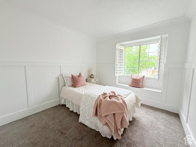 1170 N Main St, Orem, UT 84057 - carpeted bedroom with a decorative wall, ornamental molding, and wainscoting
