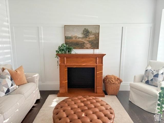 1170 N Main St, Orem, UT 84057 - living room featuring dark wood finished floors, a fireplace, and a decorative wall
