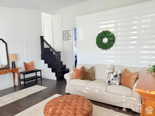 1170 N Main St, Orem, UT 84057 - living area with a decorative wall, wood finished floors, stairway, and wainscoting