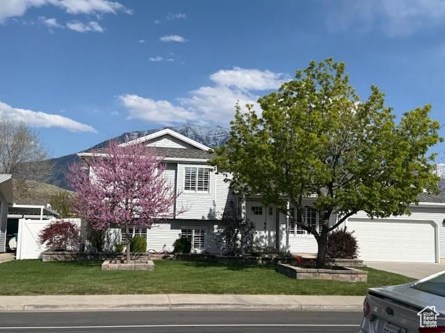 1170 N Main St, Orem, UT 84057 - view of front facade with a front yard, a mountain view, and driveway