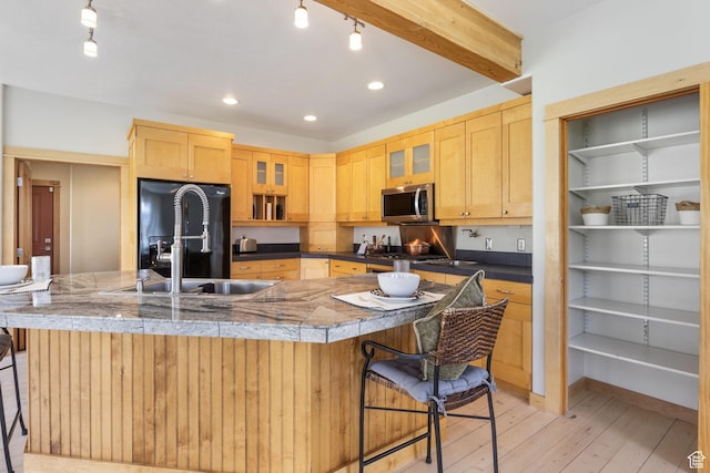933 N Swiss Farm Ct, Midway, UT 84049 - kitchen featuring light brown cabinetry, stainless steel microwave, a breakfast bar area, and black refrigerator with ice dispenser