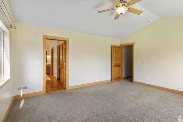 933 N Swiss Farm Ct, Midway, UT 84049 - unfurnished bedroom with visible vents, vaulted ceiling, baseboards, light carpet, and ensuite bath