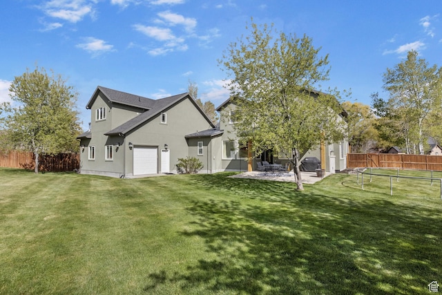 933 N Swiss Farm Ct, Midway, UT 84049 - back of property with a lawn, a trampoline, stucco siding, and fence