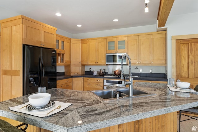 933 N Swiss Farm Ct, Midway, UT 84049 - kitchen with black refrigerator with ice dispenser, a breakfast bar, glass insert cabinets, stainless steel microwave, and a sink