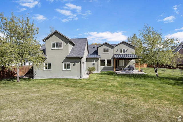 933 N Swiss Farm Ct, Midway, UT 84049 - back of house with a lawn, a standing seam roof, a fenced backyard, and a patio area