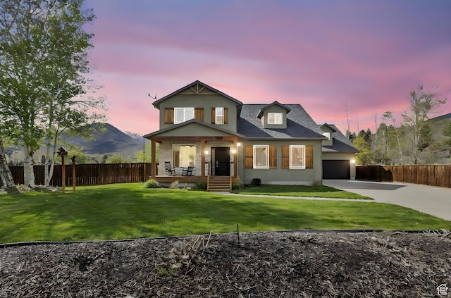 933 N Swiss Farm Ct, Midway, UT 84049 - rear view of house with fence, a yard, covered porch, and concrete driveway