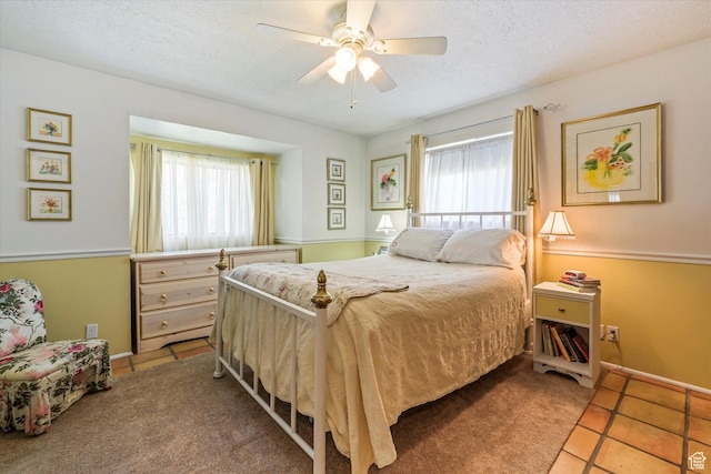 1597 E 8900 S, Paradise, UT 84328 - bedroom with multiple windows, tile patterned flooring, a ceiling fan, a textured ceiling, and baseboards