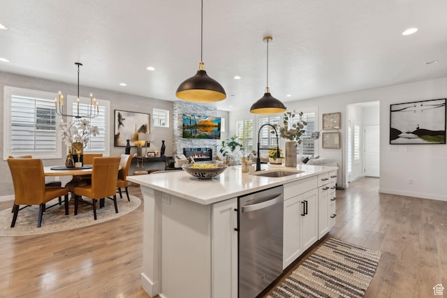 5346 W Canary Grass Way S, South Jordan, UT 84009 - kitchen featuring a sink, dishwasher, open floor plan, a fireplace, and baseboards