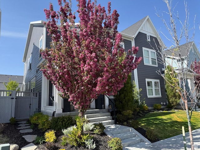 view of front of house with fence, a gate, and a front yard