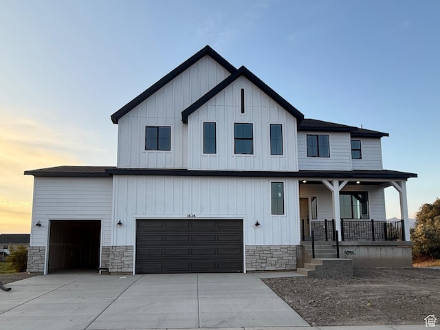 1626 E Livi Ln N Unit 2, Saratoga Springs, UT 84043 - view of front facade featuring covered porch, stone siding, board and batten siding, and concrete driveway