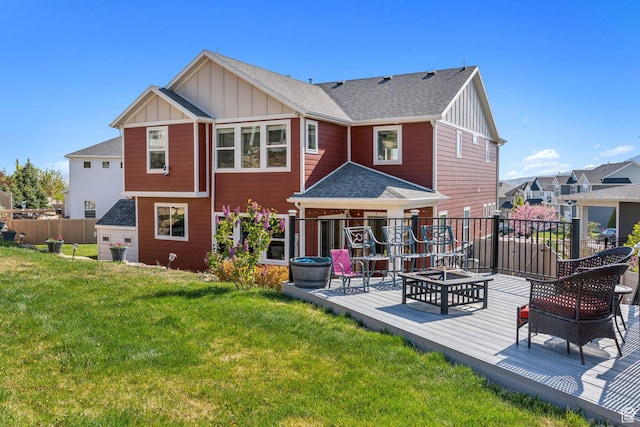 4852 N Arctic Fox Cir W Unit 2800, Lehi, UT 84043 - back of property with fence, board and batten siding, a deck, a lawn, and a fire pit