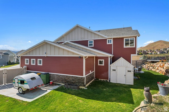 4852 N Arctic Fox Cir W Unit 2800, Lehi, UT 84043 - back of house featuring an outdoor structure, fence, a storage unit, board and batten siding, and a yard
