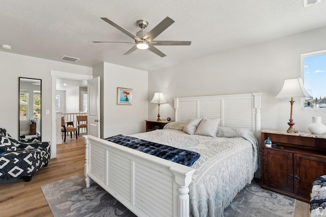 4852 N Arctic Fox Cir W Unit 2800, Lehi, UT 84043 - bedroom with visible vents, a textured ceiling, light wood-style flooring, and ceiling fan