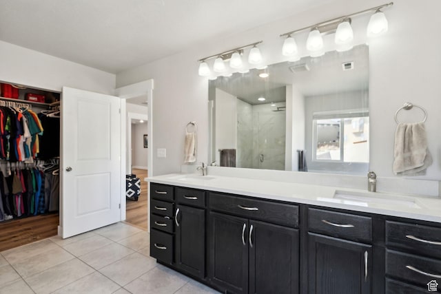 4852 N Arctic Fox Cir W Unit 2800, Lehi, UT 84043 - bathroom with a spacious closet, a sink, tile patterned flooring, and a stall shower