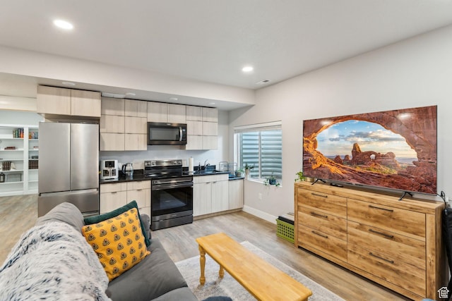 4852 N Arctic Fox Cir W Unit 2800, Lehi, UT 84043 - kitchen featuring appliances with stainless steel finishes, modern cabinets, dark countertops, light wood finished floors, and recessed lighting